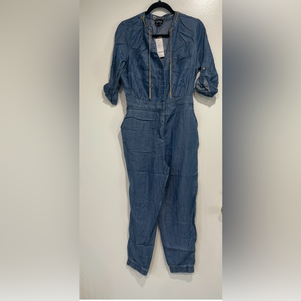 Bebe Blue Denim Jumpsuit with chain Details. Size M. NWT